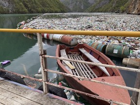 In this photo taken on Tuesday, April 23, 2019, plastic bottles and other garbage float in river Drina near Visegrad, eastern Bosnia-Herzegovina. Plastic bottles, rusty barrels and even old washing machines are among tons of garbage clogging rivers in Bosnia that were once famous for their emerald color and crystal clear waters adored by rafters and adventurers as well as fishermen.