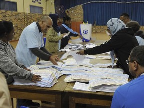 In this photo taken Wednesday, May 8, 2019, vote counting begins at a polling station in Cape Town, South Africa. Vote counting continued Thursday May 9, 2019 after South Africans voted Wednesday in a national election that pits President Cyril Ramaphosa's ruling African National Congress against top opposition parties Democratic Alliance and Economic Freedom Fighters, 25 years after the end of apartheid.