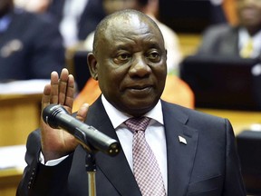 In this photo supplied by the South African Government Communications and Information Services (GCIS) Cyril Ramaphosa is sworn in as a member of parliament in Cape Town, South Africa, Wednesday, May 22, 2019. Ramaphosa has taken steps to crack down on corruption Wednesday as the country's new parliament voted him to lead the country for a five-year term.