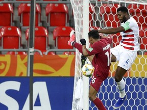 United States' Mark McKenzie, right, tries to block a shot from Qatar's Hashim Ali during the Group D U20 World Cup soccer match between USA and Qatar, in Tychy, Poland, Thursday, May 30, 2019.