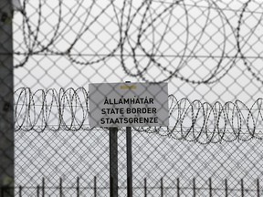 In this photo taken Monday, April 8, 2019, a sign reading: "State Border" is attached to a fence at Hungary's border with Serbia near the village Asotthalom, Hungary. With a campaign centered on stopping immigration, Hungary's ruling Fidesz party is expected to continue its dominance in the European Parliament election at the end of May. While Hungary has been practically closed to immigrants from the Middle East, Asia and Africa since Prime Minister Viktor Orban had border fences built in 2015, he continues to warn voters about the threat of a "migrant invasion" that would put at risk Europe's Christian culture.