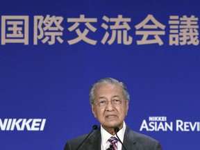 Malaysia's Prime Minister Mahathir Mohamad delivers a keynote speech at the special session of the International Conference on "The Future of Asia" Thursday, May 30, 2019, in Tokyo. Mahathir called for talks to resolve the ongoing trade dispute between Washington and Beijing and urged the world to accept China's technological prowess. The U.S. cannot expect to always be at the top in technology, and countries need to talk to deal with a powerful China, Mahathir said.