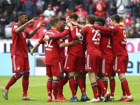 Bayern's players celebrate after scoring their side's third goal during the German Bundesliga soccer match between FC Bayern Munich and Hannover 96 in Munich, Germany, Saturday, May 4, 2019.
