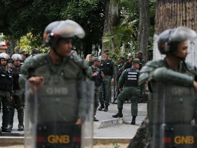 Venezuelan Bolivarian National stand guard around the National Assembly building as the opposition-controlled congress met to discuss a move could provide political cover for greater international involvement in the nation's crisis, in Caracas, Venezuela, Tuesday, May 7, 2019. Military police prevented journalists from entering the National Assembly, and some reporters were harassed by government supporters outside the building.