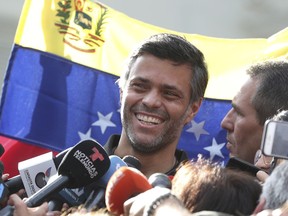 Venezuelan opposition leader Leopoldo Lopez smiles during a press conference at the gate of the Spanish ambassador's residence in Caracas, Venezuela, Thursday, May 2, 2019. López said he expects that the country's military will step up to overthrow President Nicolas Maduro despite setbacks.