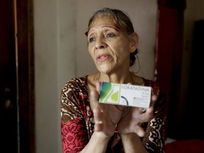 In this April 11, 2019 photo, Bertha Dun shows medicine bought with cryptocurrency through online transfers, in Barquisimeto, Venezuela, Thursday, April 11, 2019. Venezuela's political and economic crisis has now made it a prime testing ground using cryptocurrency to finance social projects or send relief directly to people living in poverty.