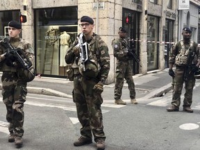 Soldiers of French antiterrorist plan "Vigipirate Mission", secure the access near the site of a suspected bomb attack in central Lyon, Friday May, 24, 2019. A small explosion Friday on a busy street in the French city of Lyon lightly injured several people, local officials said.