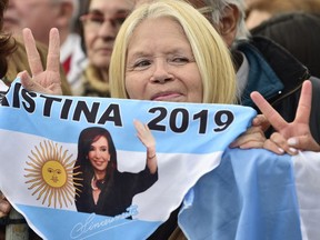 A supporters of presidential candidate Alberto Fernandez and his running-mate, former President Cristina Fernandez, no relation, holds a banner that show an image of the former leader,  during the kick-off political campaign rally,at the Nestor Kirchner Park, in Buenos Aires, Argentina, Saturday, May 25, 2019.  Argentina will hold general presidential elections on Oct 27.