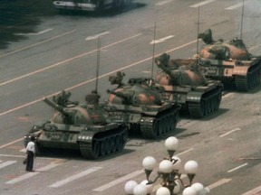 FILE - In this June 5, 1989, file photo, a Chinese man stands alone to block a line of tanks heading east on Beijing's Changan Blvd. in Tiananmen Square on Jeff Widener who created the iconic image of "tank man" says its time for China's government to "come clean" about the bloody events of June 3-4 1989.