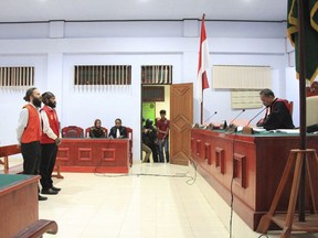 Polish national Jakub Skrzypski, left, and his Indonesian co-defendant Simon Magal listen during their sentencing hearing at the district court in Wamena, Papua province, Indonesia, Thursday, May 2, 2019. Skrzypski was sentenced Thursday to five years in prison in Indonesia for treason after meeting with Papuan independence supporters.