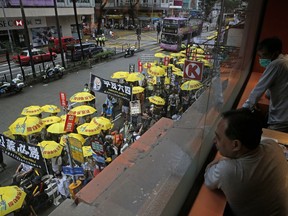 Pro-democracy protesters carry a banner with Chinese reads "Vindicate June 4th" during a demonstration in Hong Kong, Sunday, May 26, 2019. A vigil will be held on June 4 at the Victoria Park to mark the 30th anniversary of the military crackdown on the pro-democracy movement at Beijing's Tiananmen Square on June 4, 1989.