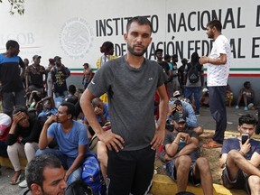 FILE - In this April 29, 2019 file photo, Rahjit, from India, poses for a photo as he waits with other migrants for a ticket to register their entry into Mexico at an immigration station in Tapachula, Chiapas state, Mexico. The National Immigration Institute said on Monday, May 20, 2019, it is studying a change in the way it handles the migrants who have been overwhelming its facilities near the border with Guatemala.