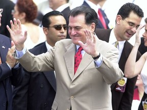 FILE - In this July 25, 2002 file photo, former Puerto Rican Gov. Rafael Hernández Colón waves to the crowd during a celebration at the Capitol in San Juan, Puerto Rico. Hernández Colón, who oversaw one of the U.S. territory's most prosperous periods, died on Thursday, May 2, 2019.  He was 82.
