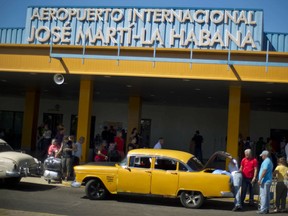 FILE - In this Sept. 1, 2014 file photo, people put their luggage in a private taxi as they arrive from the U.S. to the Jose Marti International Airport in Havana, Cuba. In 1958, the father of José Ramón López owned Cuba's main airport, its national airline and three small hotels. All were taken in Cuba's socialist revolution. Starting Thursday, they will be able to file lawsuits against European and American companies doing business on their former properties, thanks to the Trump administration's decision to activate a provision of the U.S. embargo on Cuba with the potential to affect foreign investment in Cuba for many years to come.