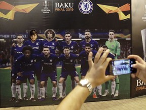 Tourists take pictures in at the fan zone in Baku, Azerbaijan, Tuesday May 28, 2019. English Premier League teams Arsenal and Chelsea are preparing for the Europa League Final soccer match that takes place in Baku on Wednesday night.