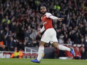 Arsenal's Alexandre Lacazette celebrates after scoring his side's first goal during the Europa League semifinal first leg soccer match between Arsenal and Valencia at the Emirates stadium in London, Thursday, May 2, 2019.
