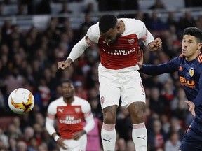 Arsenal's Alexandre Lacazette heads the ball to score his side's second goal, during the Europa League semifinal first leg soccer match between Arsenal and Valencia at the Emirates stadium in London, Thursday, May 2, 2019.
