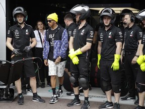Mercedes driver Lewis Hamilton of Britain stands by technicians at the Monaco racetrack, in Monaco, Friday, May 24, 2019. The Formula one race will be held on Sunday.