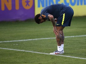 Brazil's soccer player Neymar touches his left knee during a practice session at the Granja Comary training center ahead of the Copa America tournament, in Teresopolis, Brazil, Tuesday, May 28, 2019.