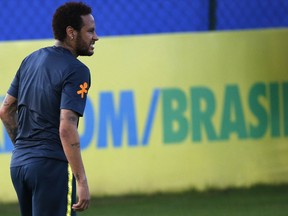 Brazil's soccer player Neymar grimaces after touching his knee during a practice session at the Granja Comary training center ahead of the Copa America tournament, in Teresopolis, Brazil, Tuesday, May 28, 2019.