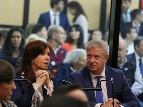 Former President Cristina Fernandez speaks with her lawyer Carlos Beraldi inside a federal courtroom in Buenos Aires, Argentina, Tuesday, May 21, 2019. Fernandez is in court for the first in a series of corruption trials.