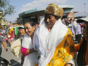 Nepalese veteran Sherpa guide Kami Rita, 49, is welcomed by his wife at the airport in Kathmandu, Nepal, Saturday, May 25, 2019. The Sherpa mountaineer extended his record for successful climbs of Mount Everest with his 24th ascent of the world's highest peak on Tuesday.