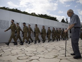 Israeli honor guards march in formation during rehearsal just before a ceremony marking the annual Memorial Day to remember fallen soldiers and victims of terror, at the Armored Corps memorial site in Latrun, Israel, Wednesday, May 8, 2019. Israel marks the annual Memorial Day in remembrance of soldiers who died in the nation's conflicts.