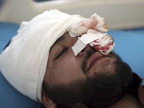 A wounded man receives treatment in a hospital after a bomb explosion during Friday prayer on the outskirts of Kabul, Afghanistan, Friday, May 24, 2019.  According to Kabul police chief's spokesman, Basir Mujahid, the bomb was concealed in the microphone used to deliver the sermon. The prayer leader, Maulvi Samiullah Rayan, was the intended target, the spokesman added.