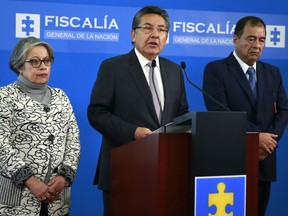 In this handout photo released by Colombia's Attorney General Press Office, chief prosecutor Nestor Martinez announces his resignation in Bogota, Colombia, Wednesday, May 15, 2019. The announcement comes after after the Special Peace Tribunal, charged with investigating crimes during the country's civil conflict, said rebel peace negotiator Seuxis Hernandez, known as Jesus Santrich, should not be extradited to the United States on a drug warrant and should be freed from jail. Also pictured is Deputy Attorney General María Paulina Riveros, left and Attorney's Coordinator Fabio Espitia.