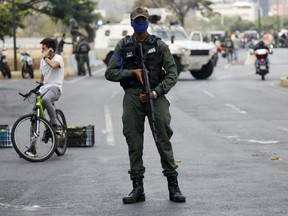 A soldier stands on an avenue leading to La Carlota air base in Caracas, Venezuela, Tuesday, April 30, 2019. Venezuelan opposition leader Juan Guaido has called for a military uprising, in a video shot at the air base showing him surrounded by soldiers and accompanied by detained activist Leopoldo Lopez.