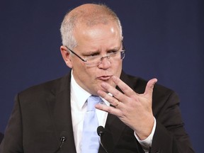 Australian Prime Minister Scott Morrison gestures as he speaks to party supporters after his opponent concedes defeat in the federal election in Sydney, Australia, Sunday, May 19, 2019. Australia's ruling conservative coalition, lead by Morrison, won a surprise victory in the country's general election, defying opinion polls that had tipped the center-left opposition party to oust it from power and promising an end to the revolving door of national leaders.