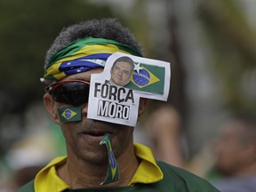 A man wears the Portuguese message: "Be strong Moro," referring to Brazil's Justice Minister Sergio Moro," during a pro-government rally on Copacabana beach in Rio de Janeiro, Brazil, Sunday, May 26, 2019. Moro recently saw Congress reject President Jair Bolsonaro's move to put him in charge of the country's financial regulator and is having trouble passing a sweeping "anti-crime" bill in Congress.