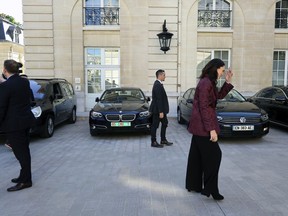 New Zealand Prime Minister Jacinda Ardern, right, leaves after a press conference, at the OECD headquarters, in Paris, Tuesday, May 14, 2019. The leaders of France and New Zealand will make a joint push to eliminate acts of violent extremism from being shown online, in a meeting with tech leaders in Paris on Wednesday.