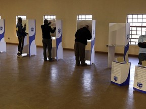 South Africans fill ballot paper at a polling station during elections at KwaMhlanga in Mpumalanga, South Africa, Wednesday, May 8, 2019. South Africans have started voting in presidential and parliamentary elections amid issues of corruption and unemployment.