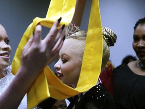 Ayanda Sibanda smiles, after being crowned Miss Albinism Zimbabwe 2019 at an albino pageant held in Harare, early Saturday, May 25, 2019. About 70,000 of Zimbabwe's estimated 16 million people are born with albinism, according to government figures. They often stand out, making them a subject at times of discrimination, ridicule and dangerously misguided beliefs. The Mr. and Miss Albinism Zimbabwe competition, now in its second year, is a chance to push back.