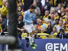 Manchester City's David Silva celebrates after scoring his side's first goal during the English FA Cup Final soccer match between Manchester City and Watford at Wembley stadium in London, Saturday, May 18, 2019.