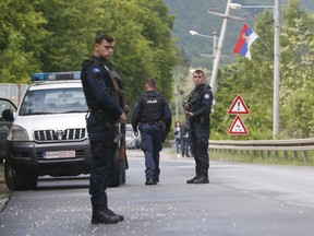 Kosovo police special unit members secure the area near the village of Cabra, north western Kosovo, during an ongoing police operation on Tuesday, May 28, 2019. A Kosovo police operation against organized crime in the north, where most of the ethnic Serb minority lives, has sparked tension, and Serbia ordered its troops to full alert.