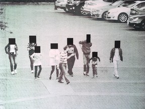 A CBSA surveillance photo attached to a search warrant application shows Michael Kong leading a group of suspected Chinese migrants through a parking lot at Parker Place mall in Richmond, B.C., on June 13, 2015.