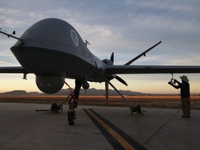 Maintenence personnel check a Predator drone operated by U.S. Office of Air and Marine (OAM), before its surveillance flight near the Mexican border on March 7, 2013 from Fort Huachuca in Sierra Vista, Arizona.