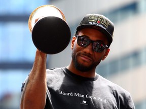 Kawhi Leonard #2 of the Toronto Raptors holds the MVP trophy during the Toronto Raptors Victory Parade on June 17, 2019 in Toronto, Canada.