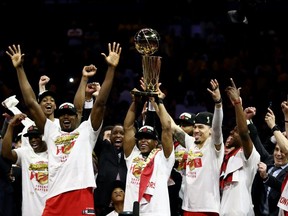 Kawhi Leonard #2 of the Toronto Raptors celebrates with the Larry O'Brien Championship Trophy after his team defeated the Golden State Warriors to win Game Six of the 2019 NBA Finals at ORACLE Arena on June 13, 2019 in Oakland, California.