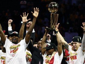 The Toronto Raptors celebrate with the Larry O'Brien Championship Trophy after their team defeated the Golden State Warriors to win Game Six of the 2019 NBA Finals.