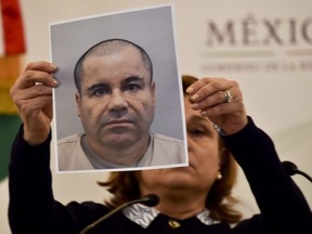 Mexico's Attorney General Arely Gomez shows a picture of Mexican drug kingpin Joaquin "El Chapo" Guzman during a press conference held at the Secretaria de Gobernacion in Mexico City, on July 13, 2015.