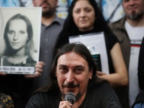 Javier Matias Mijalchuk Darroux, the 130th grandson found after being stolen and illegally adopted during the last military regime (1976-1983), speaks next to an image depicting his mother, Elena Mijalchuk, during a press conference at Abuelas de Plaza de Mayo (Grandmothers of Plaza de Mayo) human rights organization headquarters in Buenos Aires, June 13, 2019.