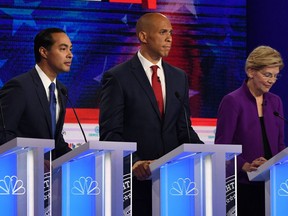 Democratic presidential hopefuls (fromL) Former US Secretary of Housing and Urban Development Julian Castro, US Senator from New Jersey Cory Booker and US Senator from Massachusetts Elizabeth Warren participate in the first Democratic primary debate of the 2020 presidential campaign season hosted by NBC News at the Adrienne Arsht Center for the Performing Arts in Miami, Florida, June 26, 2019.