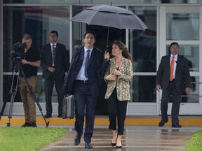 Canadian Prime Minister Justin Trudeau and his wife Sophie Gregoire Trudeau board the government plane as they depart for the G20 in Japan, on Wednesday June 26, 2019 in Ottawa.