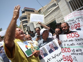 Protesters stage a demonstration outside Germany's Representative Office in Ramallah in the Palestinian West Bank on May 22, 2019, following the German parliament's condemnation of the Boycott, Divestment, Sanctions (BDS) movement as anti-Semitic.