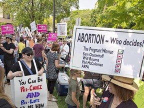 Pro-choice and anti-abortion protesters rally outside Brant MPP Will Bouma's constituency office in Brantford, Ont., on May 31, 2019.