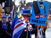 Anti-Brexit protestors stand outside the Houses of Parliament in London on March 12, 2019.