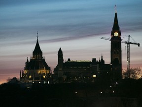 Buildings stand at sunrise on Parliament Hill in Ottawa.
